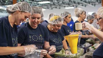 Omni employees volunteering making food Omni employees volunteering making food