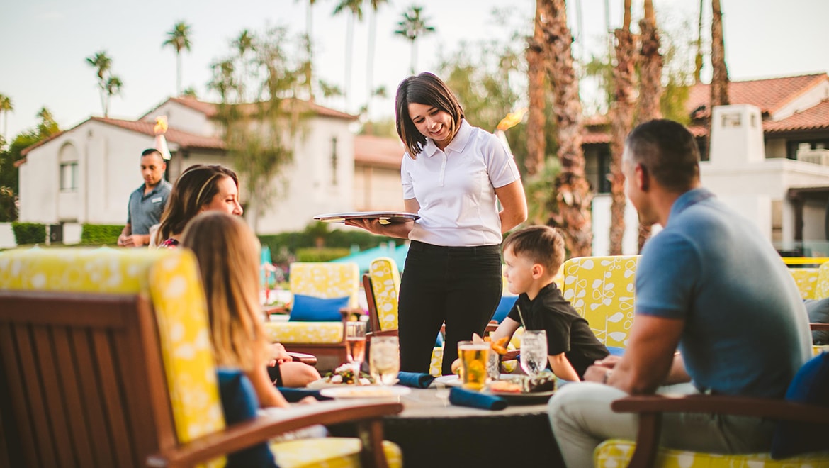 Woman serving guests food.