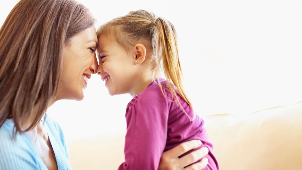 Mother holding daughter
