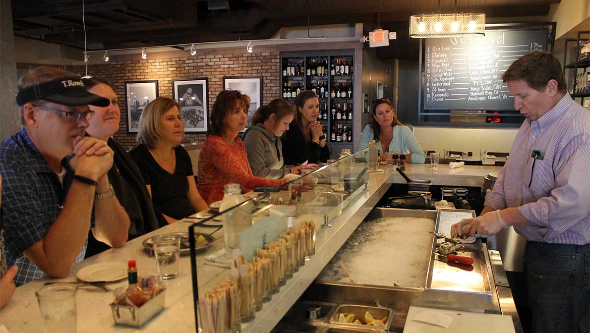 People watching sushi chef.